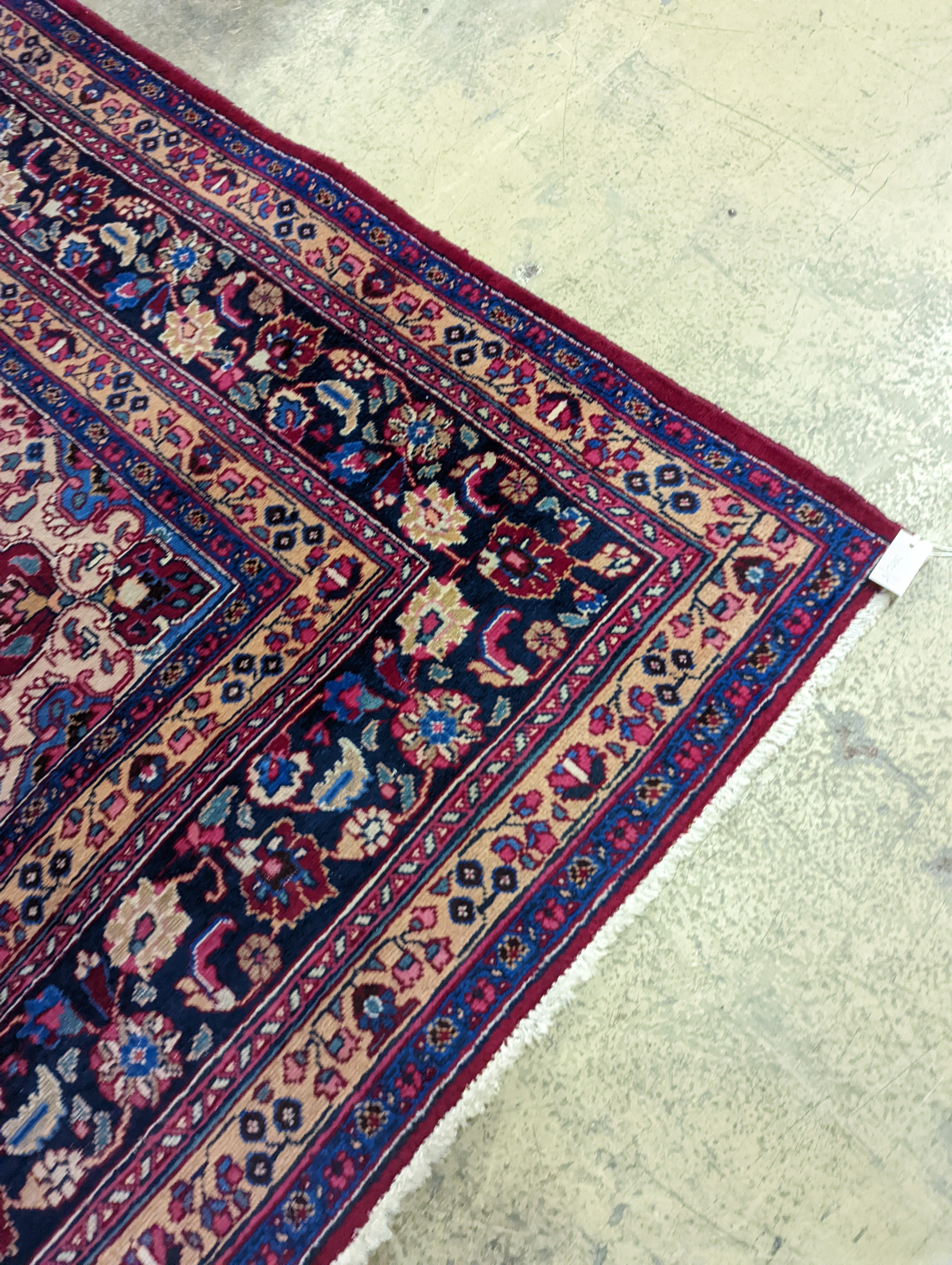 A Tabriz burgundy ground carpet, 350 x 250cm